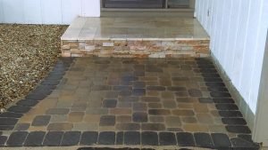 jonthan allen – paver patio – traverteen landing with a veneer facing finished with a paver patio touched with a charcoal solder course
