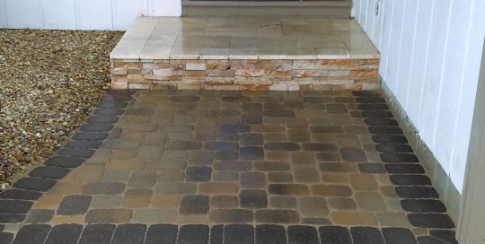 jonthan allen – paver patio – traverteen landing with a veneer facing finished with a paver patio touched with a charcoal solder course
