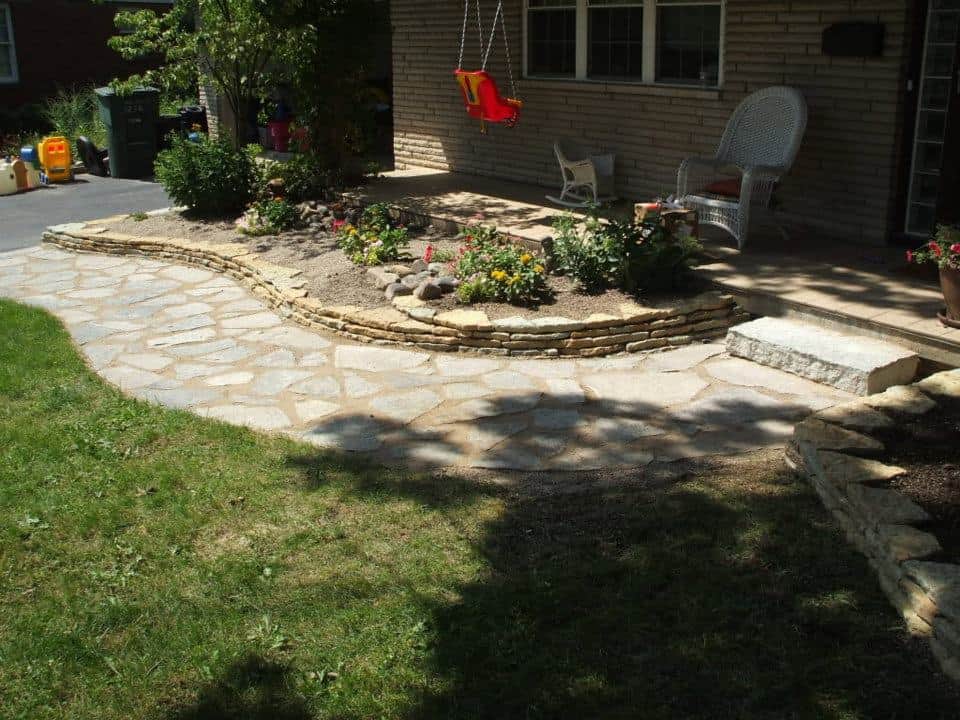 Jonathan Allen – Flagstone pic – Flag stone walkway with a natural stone wall and a single limestone step