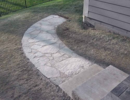 A natural flagstone walkway with two 400 lbs limestone steps incorporated